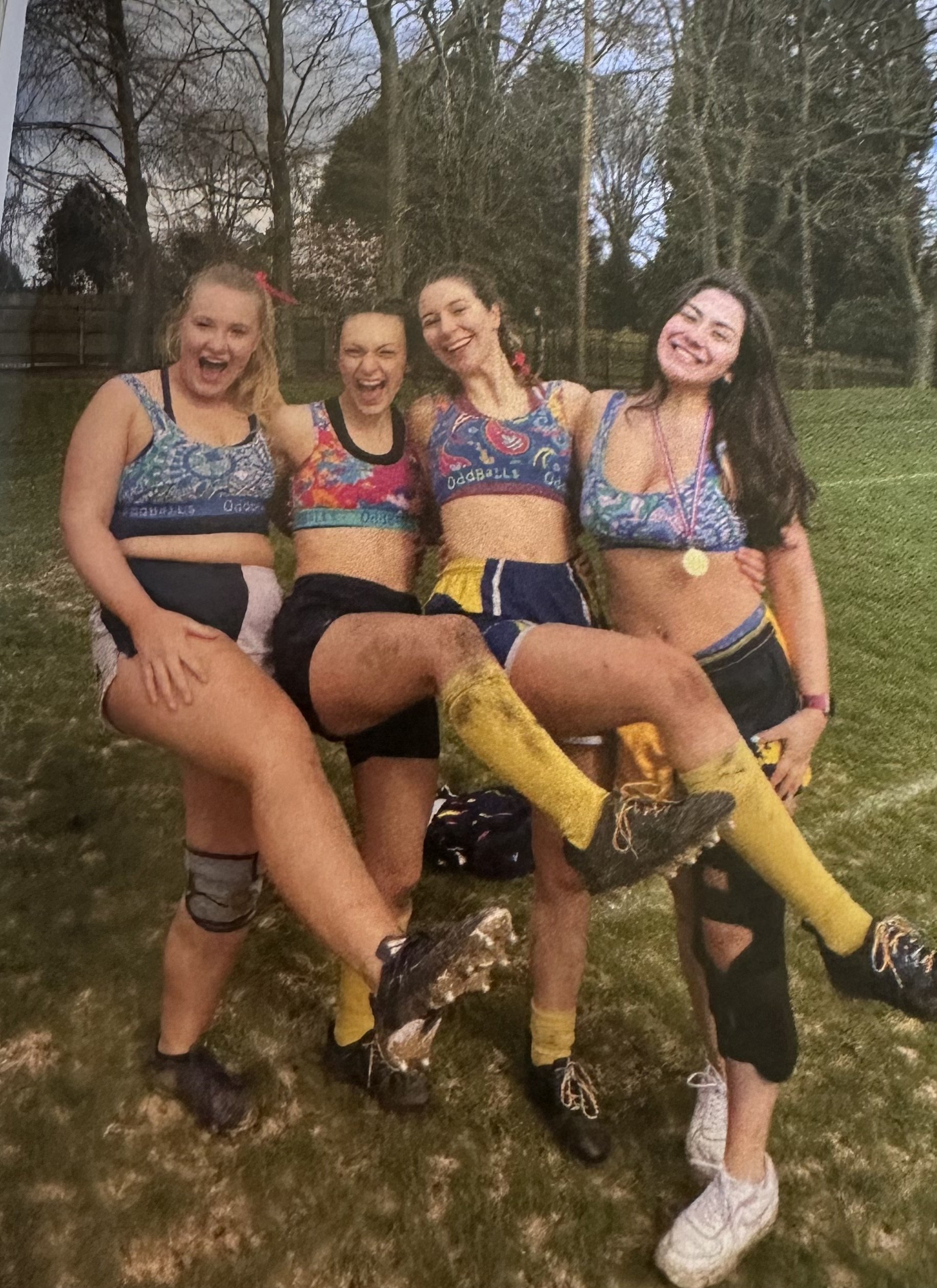 Eliza and friends sitting together after rugby.
