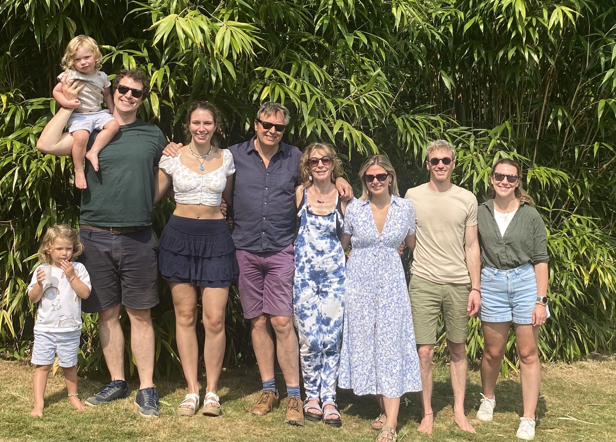 Eliza with family in a sunny garden.