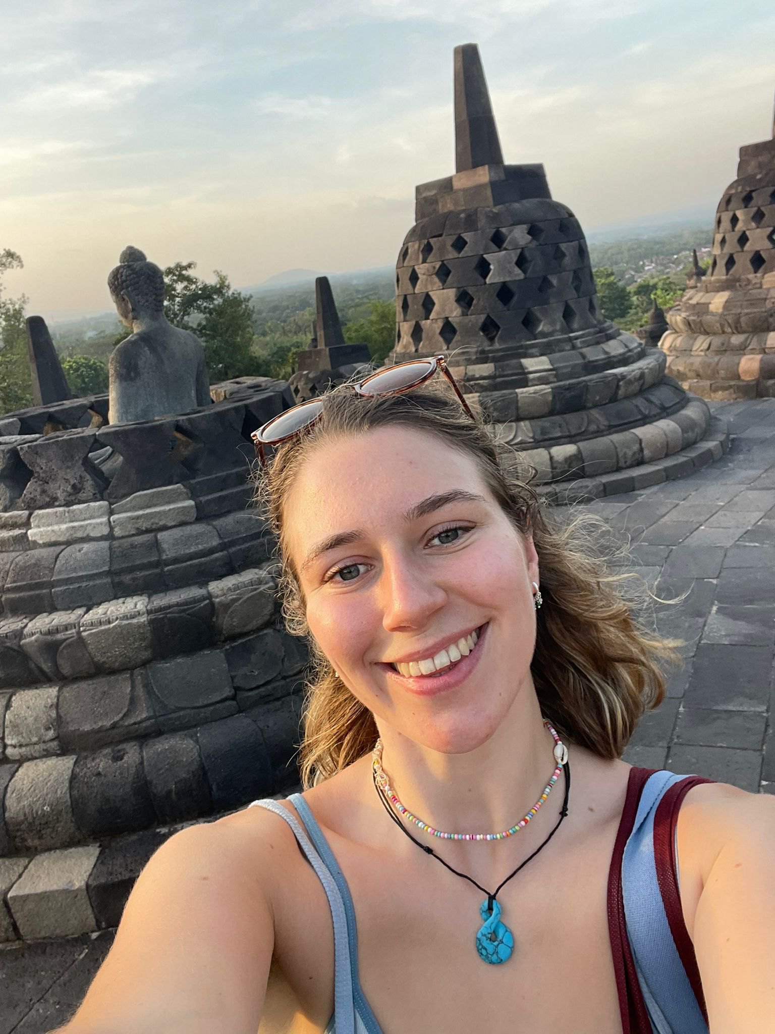 Eliza smiling during her travels.